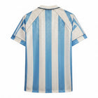 Hinchas Sportswear Store Argentina 1996 retro home jersey, light blue and white vertical stripes, jacquard watermark pattern, polo collar, black piping.