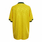 Hinchas Sportswear Store Brazil 1991-93 retro home jersey in canary yellow with dark green trim and jacquard 'BRASIL' pattern.