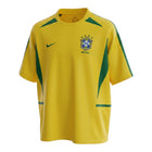 Hinchas Sportswear Store Brazil 2002 World Cup home jersey in yellow with green accents, featuring the iconic CBF crest and Nike swoosh.