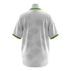 Hinchas Sportswear Store white Brazil away jersey with palm leaf pattern, featuring tricolor collar and cuffs.