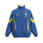 Hinchas Sportswear Store Brazil Jordan windbreaker jacket in royal blue with neon yellow panels and white piping. Features CBF Brasil crest and Jumpman logo.