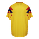 Hinchas Sportswear Store 1990 Colombia Home Jersey: vibrant yellow with red and blue lightning bolt shoulder panels and tricolor collar.