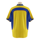 Hinchas Sportswear Store Colombia 2001 home jersey in yellow with blue panels, blue V-neck collar, and Reebok branding.