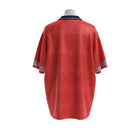 Hinchas Sportswear Store England 1990 retro red away jersey with navy polo collar and geometric cuff patterns.