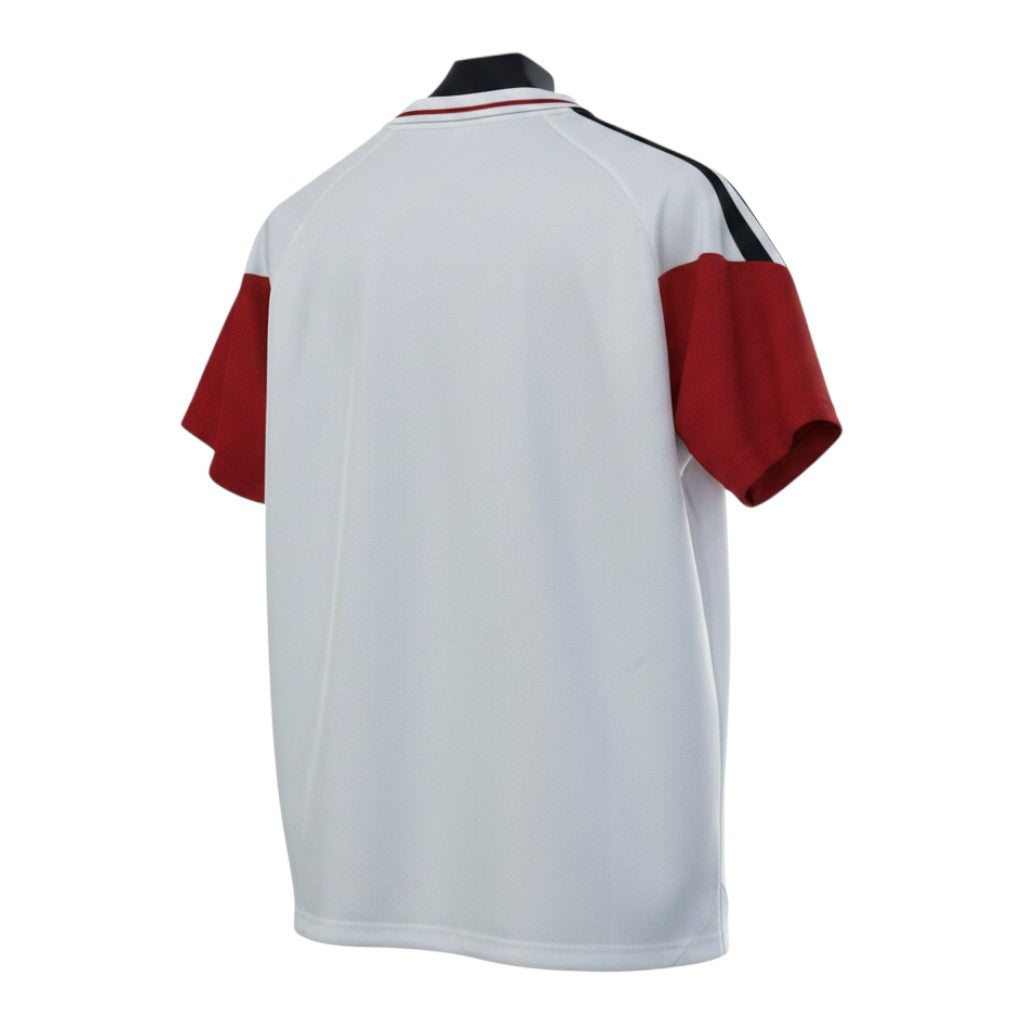Hinchas Sportswear Store Germany 2026 polo training shirt, white with red sleeves, black shoulder stripes, and ribbed collar.