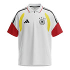 Hinchas Sportswear Store Germany 2026 polo training shirt in white with red sleeves, black Adidas stripes on shoulders, and yellow chest panels. Features a quarter zip.