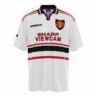 Hinchas Sportswear Store white Manchester United 1997-98 Umbro away jersey with Sharp Viewcam sponsor, black and red chest stripes, and V-neck.