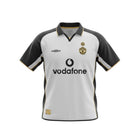 Hinchas Sportswear Store white Manchester United 2001-02 away jersey with black sleeves and gold trim. Features Vodafone sponsor and club crest.