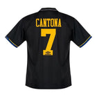 Hinchas Sportswear Store Manchester United 93-95 Cantona away jersey, black with yellow numbering and blue trim.