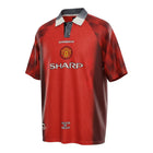 Hinchas Sportswear Store Manchester United 1996/97 retro home jersey in red with tartan sleeves, white polo collar, and SHARP sponsor.