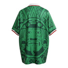 Hinchas Sportswear Store Mexico 1998 green football jersey with large Aztec graphic, white polo collar, and tricolor cuffs.