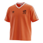 Hinchas Sportswear Store orange Adidas Netherlands 1986 retro football jersey with white V-neck and sleeve stripes.