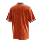 Hinchas Sportswear Store Netherlands 1991 retro home jersey, orange with geometric pattern, white polo collar with red, white, blue trim.