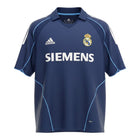Hinchas Sportswear Store navy blue Real Madrid 2005-06 away jersey with white Adidas stripes and light blue piping. Features Siemens sponsor and V-neck polo collar.