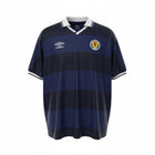 Hinchas Sportswear Store Scotland 1986 retro navy jersey with tonal hoops, white V-neck collar, and Umbro logo.