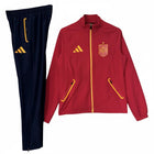 Hinchas Sportswear Store Spain national team red training jacket with gold accents and navy blue pants. Features RFEF crest and Adidas stripes.