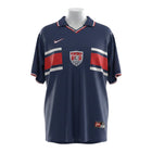 Hinchas Sportswear Store navy blue 1998 USA Away Jersey with red and white stripes, polo collar, and US Soccer crest.
