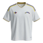 Hinchas Sportswear Store white Venezuela 2026 away jersey with gold trim and colorful stripes on shoulders.
