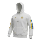 Hinchas Sportswear Store white cotton hoodie with gold Adidas and Colombia crests, and tricolor sleeve stripes.